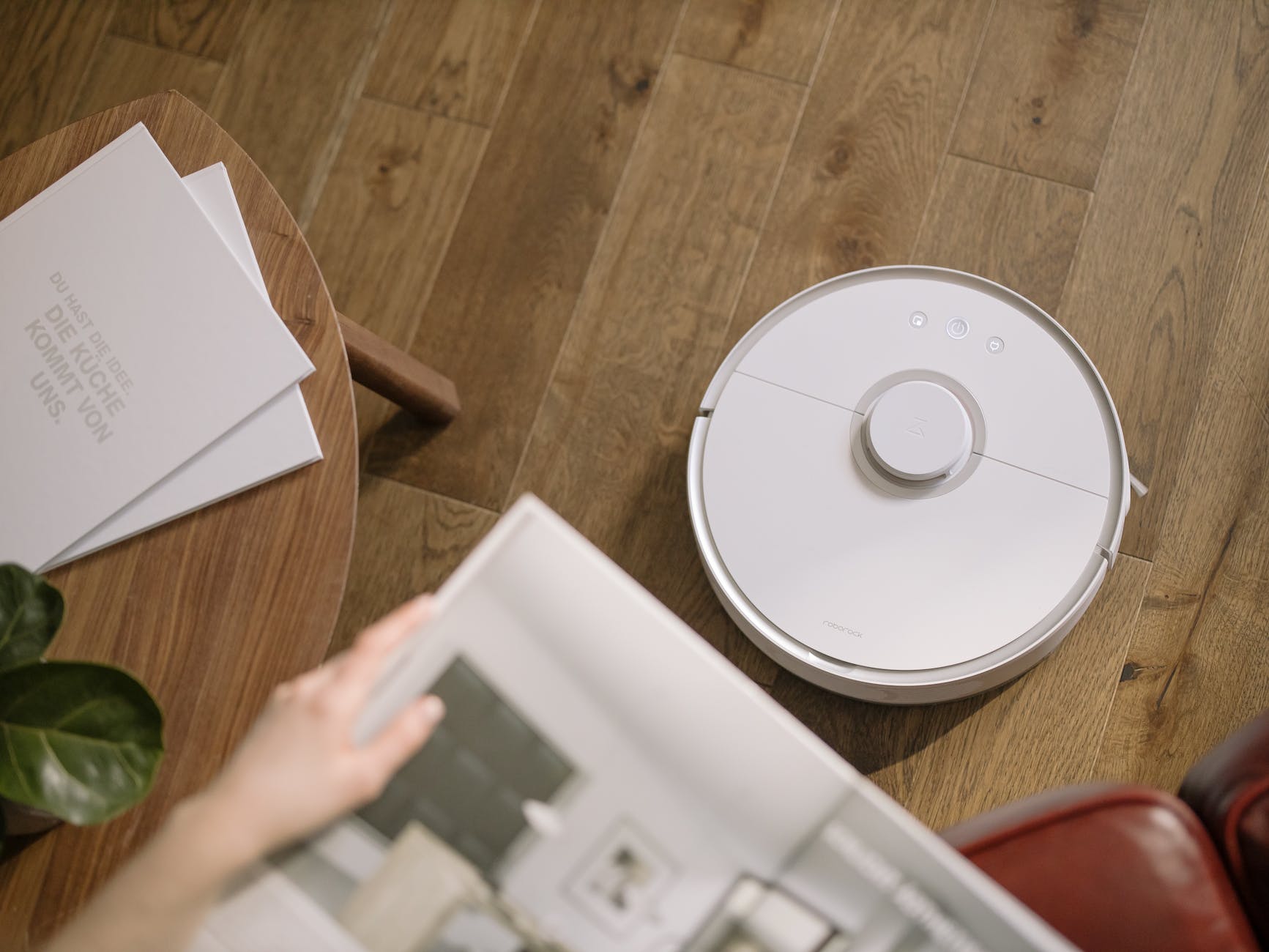 person holding white round device